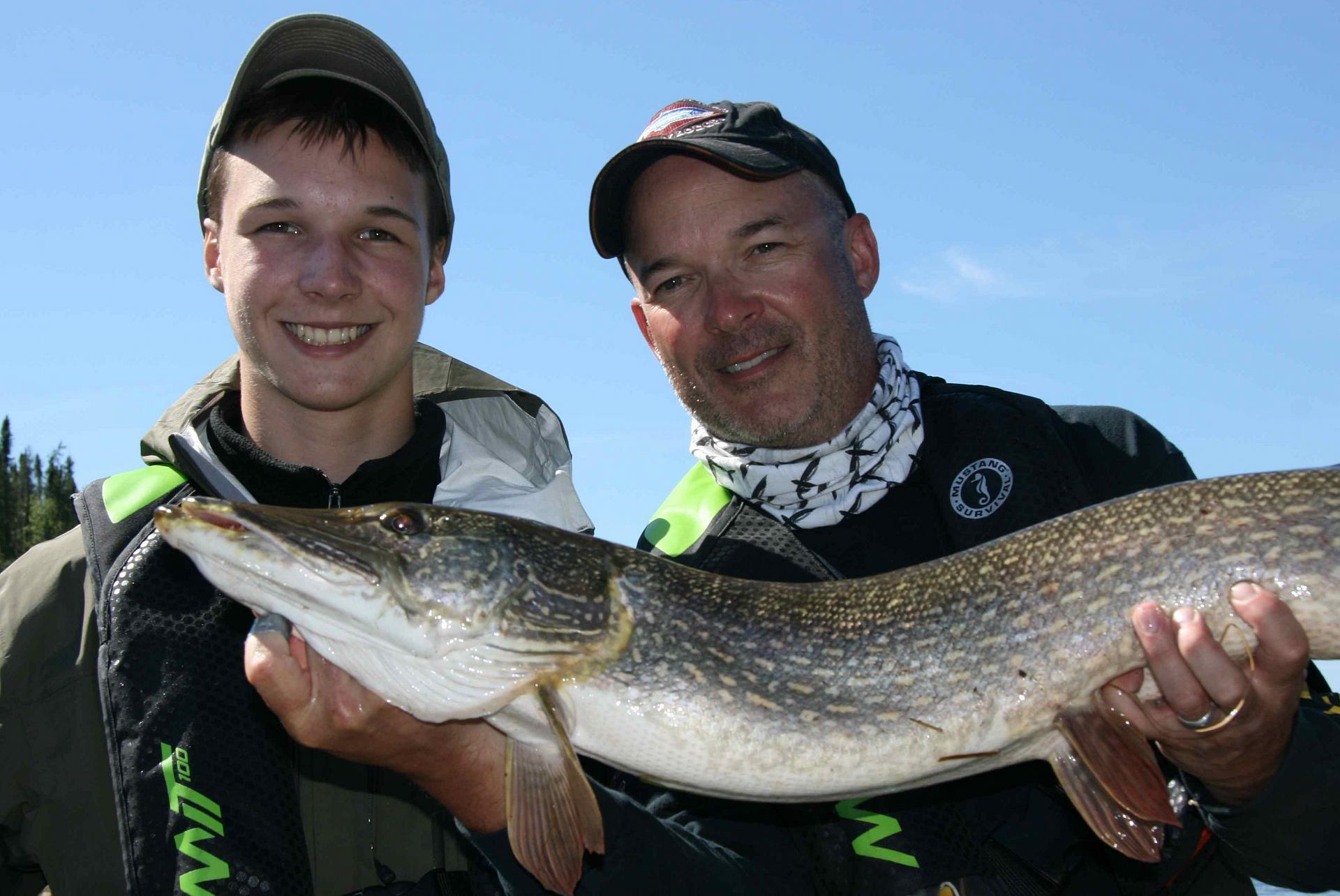 Father and son fishing at N.W.T.'s Yellow Dog Lodge