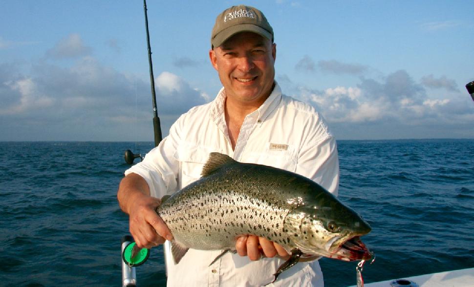 The author hoists a hefty Great Lakes brown trout. Credit: Patrick Walsh.