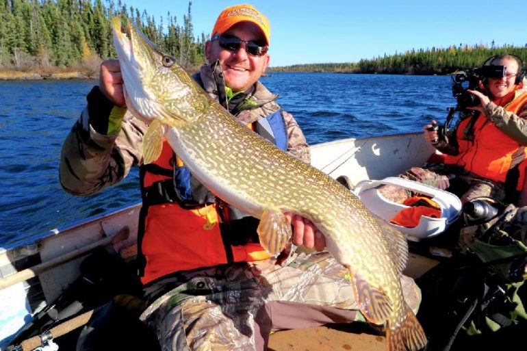 Taylor Wright hoists a beefy pike. Credit: Adrian Skok.