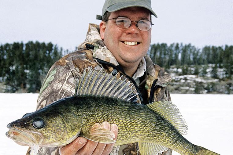 Man with winter walleye