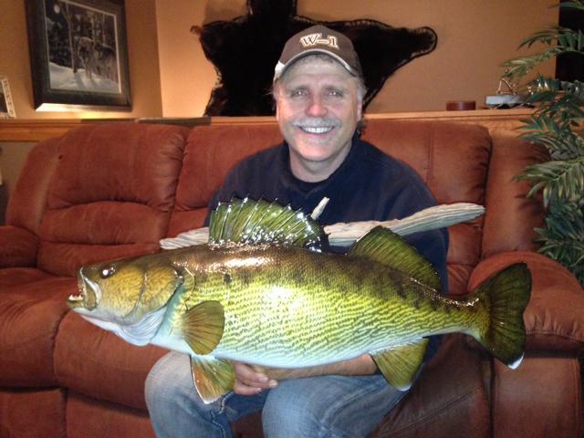 It is a picture of Dave holding a replica mount of the massive 35-inch, 15-pound plus walleye that he caught and released last August when he and his friend Dave Addie fished with me. 