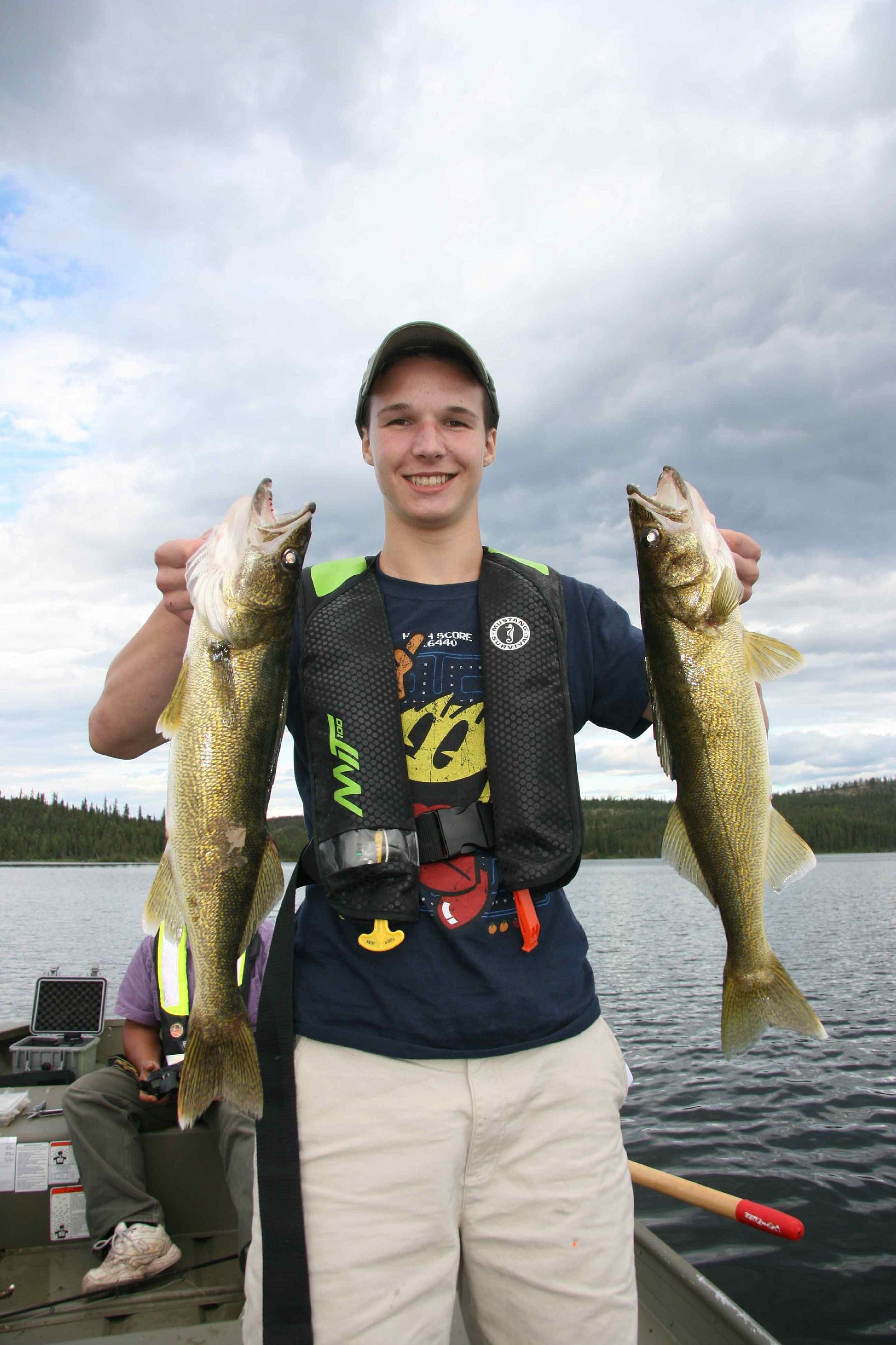 Riley Walsh and two of his nice walleye from Yellow Dog Lodge's fly out to Johnston Lake