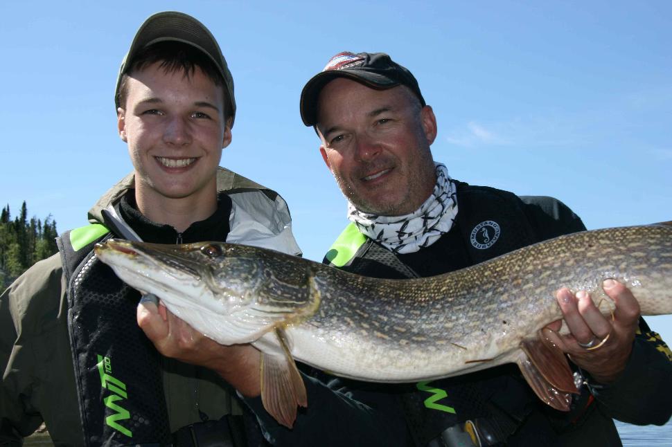 All smiles: Yours truly and my son, Riley, with one of our many pike