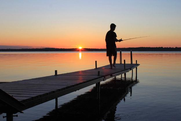 Fishing at sunrise on the cottage dock