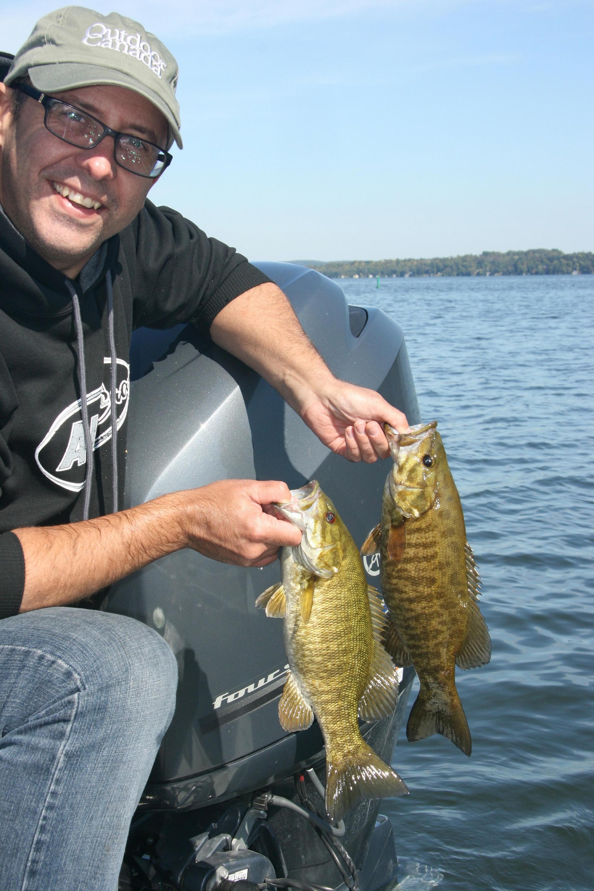 Managing editor Bob Sexton gets ready to release a pair of Rice Lake smallmouth bass