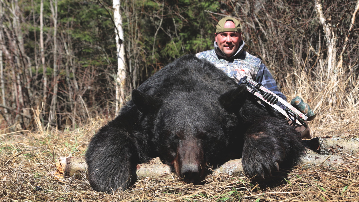 Trophy hunter Gary Gillet, with a Boone and Crockett bear that was taken over bait. Credit: Gary Gillet.