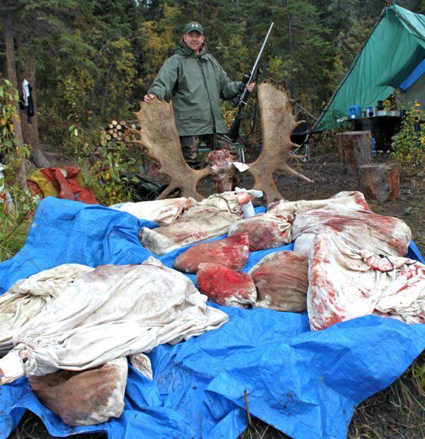 Back at camp, the author stands over the results of his successful hunt. Credit: Cody Altizer.