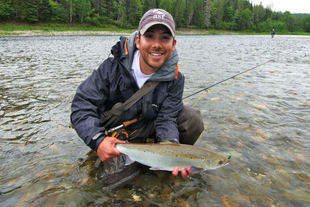 Credit: Nick Pujic. Yoshi Aoki and a grilse salmon.