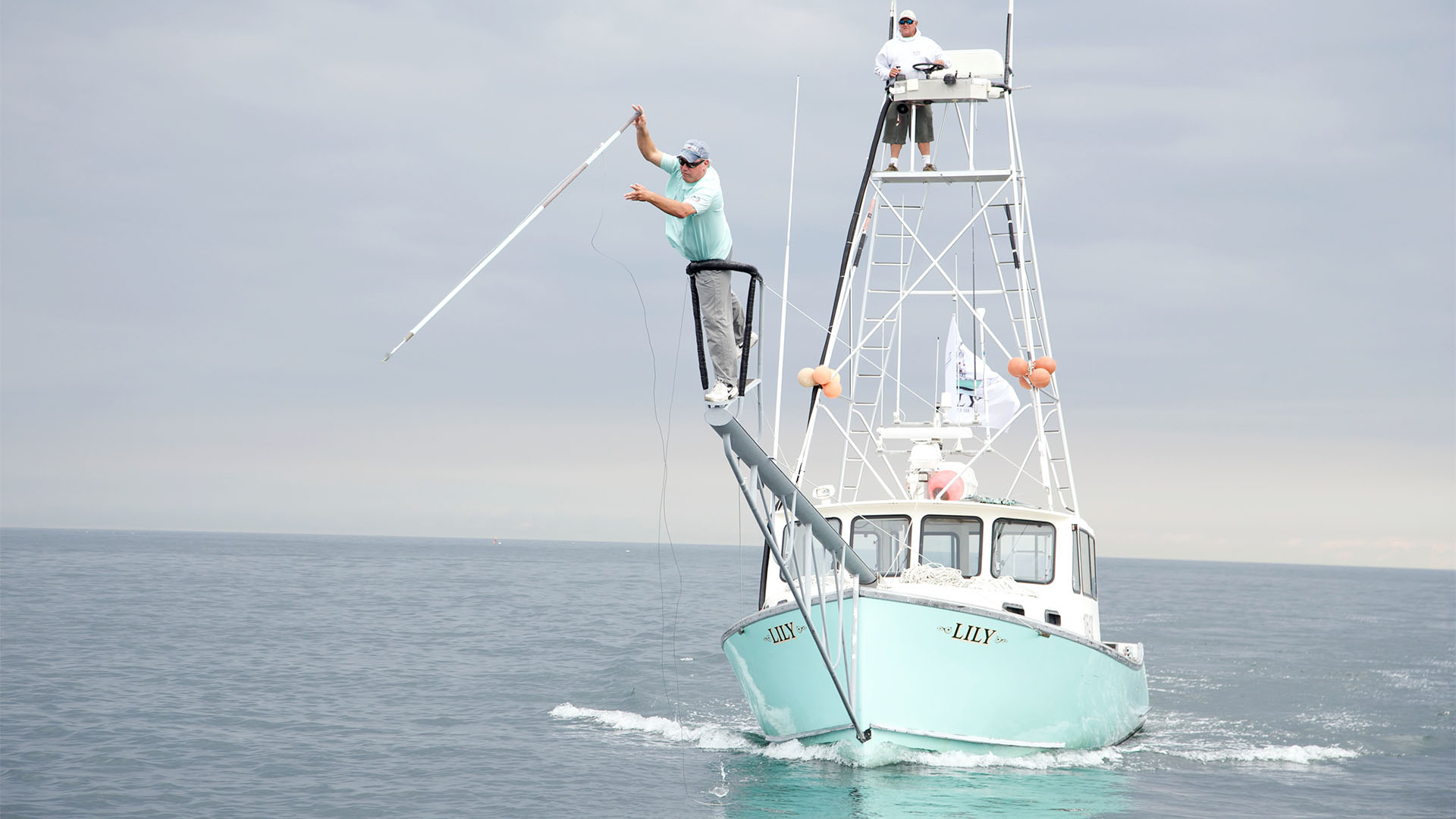 GLOUCESTER, MASS.- Captain Bill "Hollywood" Muniz takes aim with his harpoon aboard the Lily while First Mate Jimmy Lund looks on. (Photo Credit: Pilgrim Films & Television/Joe Scott)