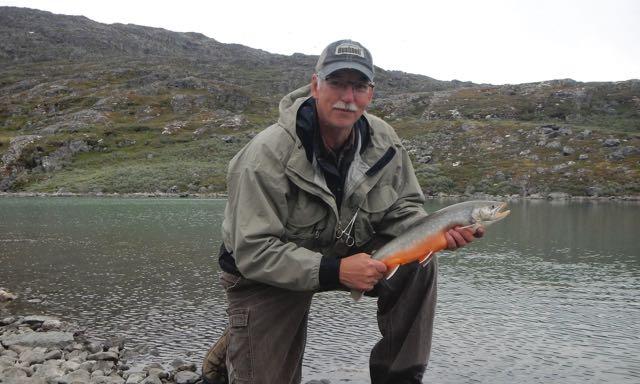 Credit: Ken Bailey. The author and an Arctic char.