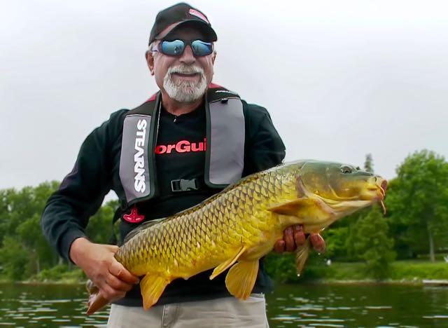 Credit: Pete Bowman. Fish'n Canada Show's Angelo Viola and a Rice Lake common carp.