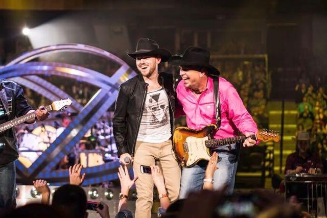 Brett Kissel (above left) perform with country music legend Garth Brooks. 