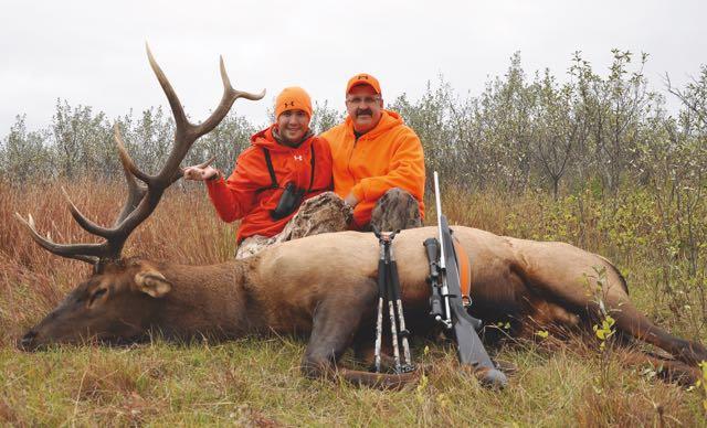 The author and his son, Kyle, with a big bull. Credit: Mike Hungle.