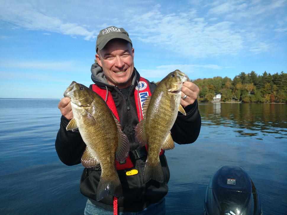 Walsh double-fists a pair of smallies he caught using a drop-shot rig in about 12 feet