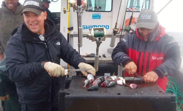 MacDonald and Nuno Antues prepare mackerel bait. Credit: Patrick Walsh.