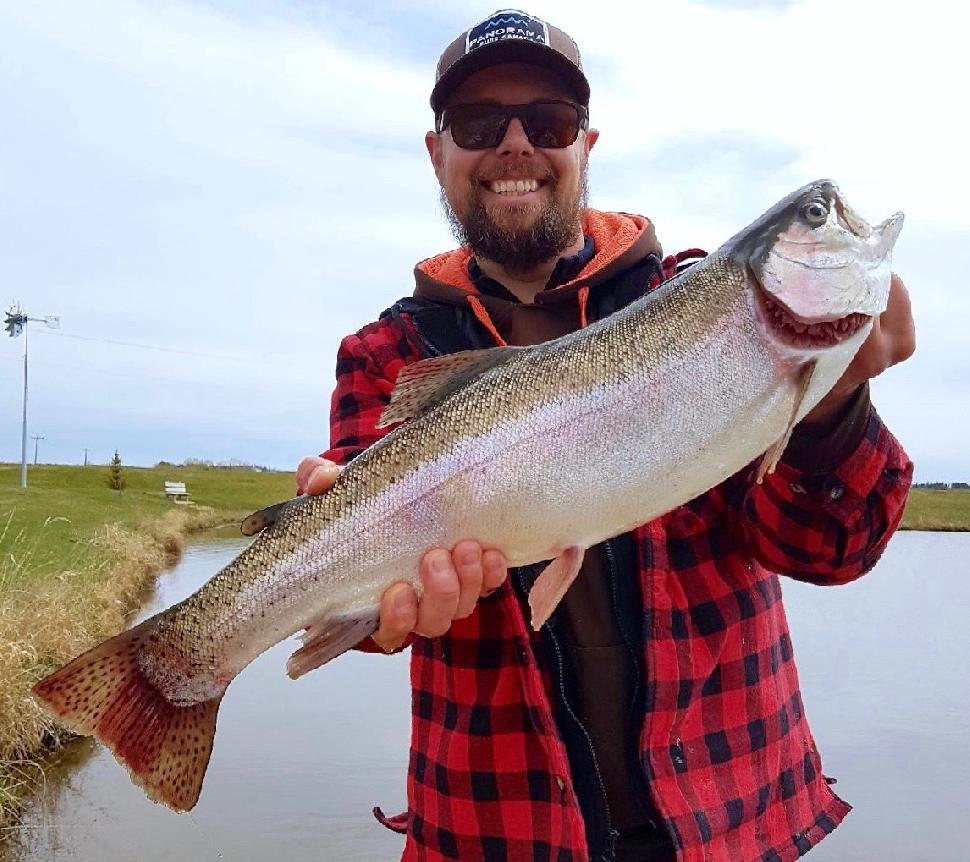 Lacombe, Alberta’s Tim Long is all smiles after catching this magnificent rainbow trout on a fine day early last spring.